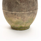 A close-up of a textured, rustic ginger root-inspired ceramic pot with a round base, showing mossy green and earthy brown tones against a plain white background. Perfect for both indoor and outdoor settings, this piece exudes timeless charm.