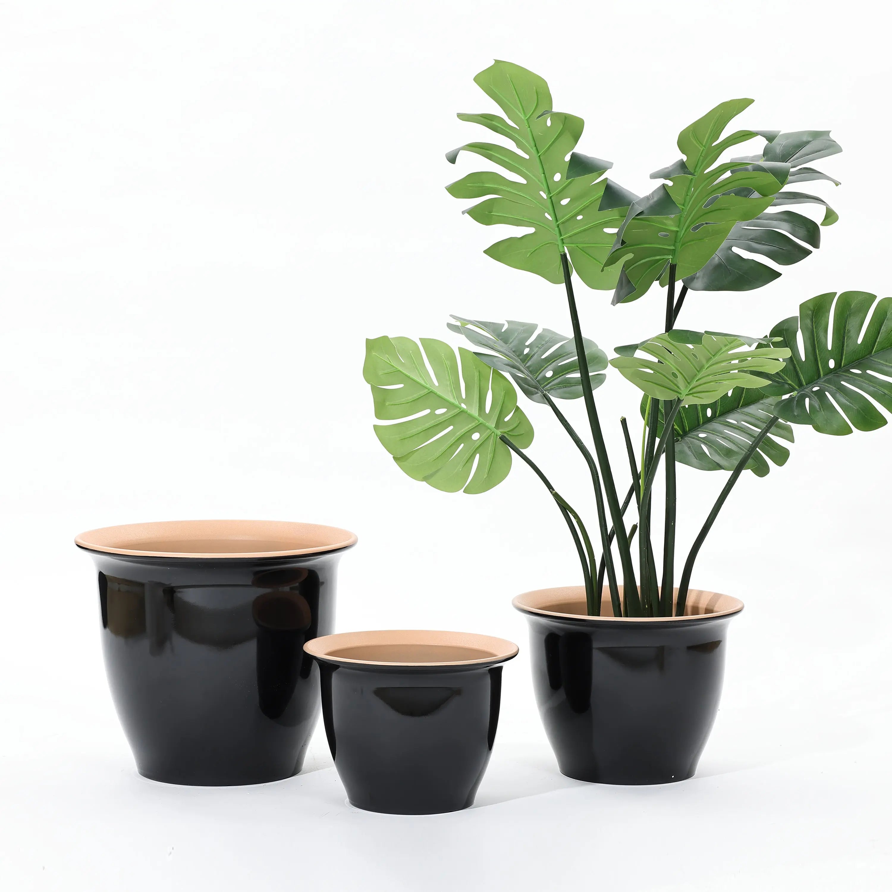 A decorative set of three black and tan planter pots, one showcasing a tall artificial Monstera plant, neatly arranged against a plain white background. Perfect for both indoor and outdoor use.