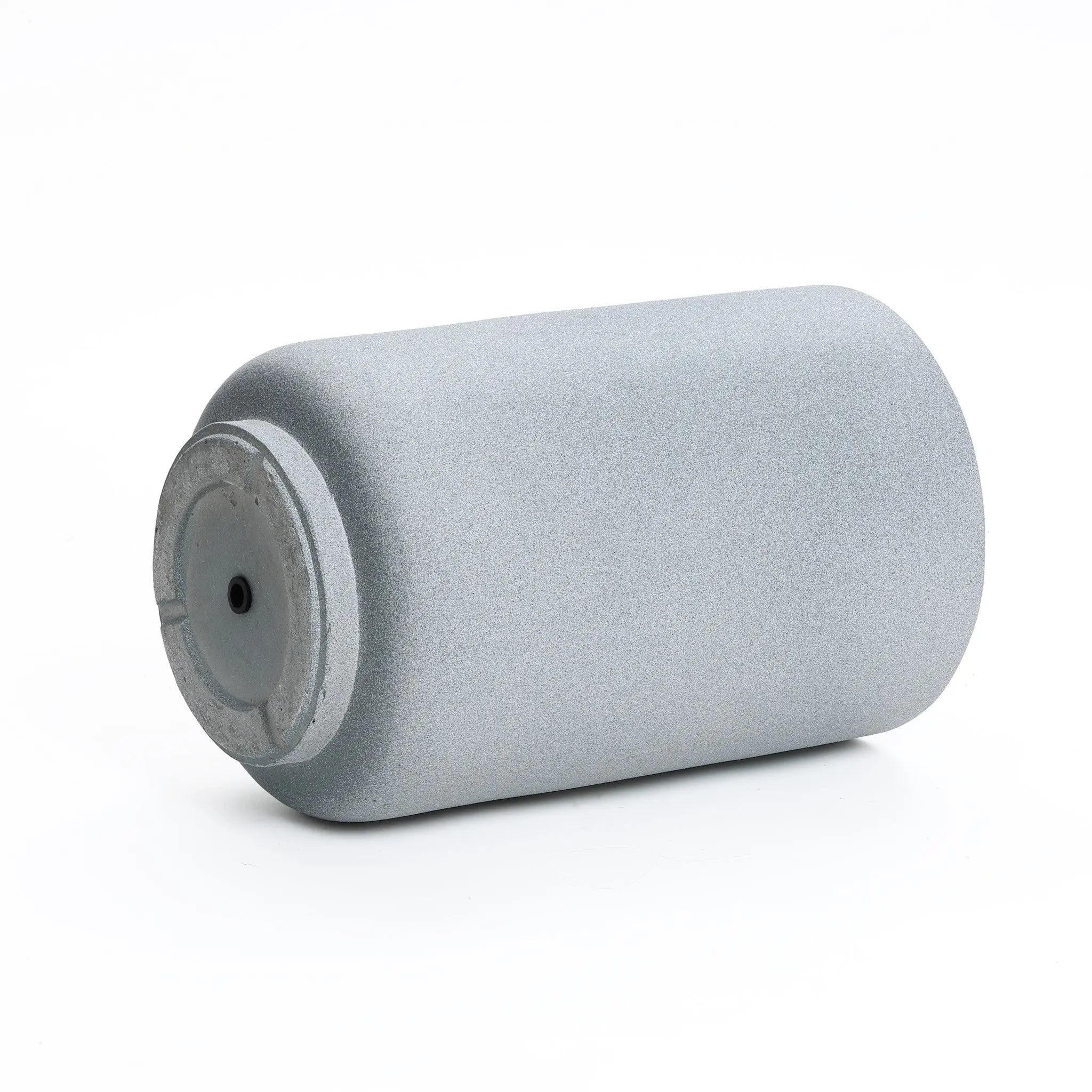 A gray, cylindrical aerosol can lies on its side against a plain white background, echoing the sleek lines of modern minimalist decor.