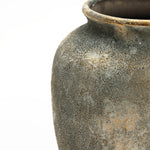Close-up of the LuxenHome Rustic Gold and Brown Terracotta Urn Vase, 15.2 H, displaying antique distressing techniques. Its narrow mouth and earthy pattern offer rustic charm for home decor, highlighted by a simple white background that beautifully showcases its textured details.