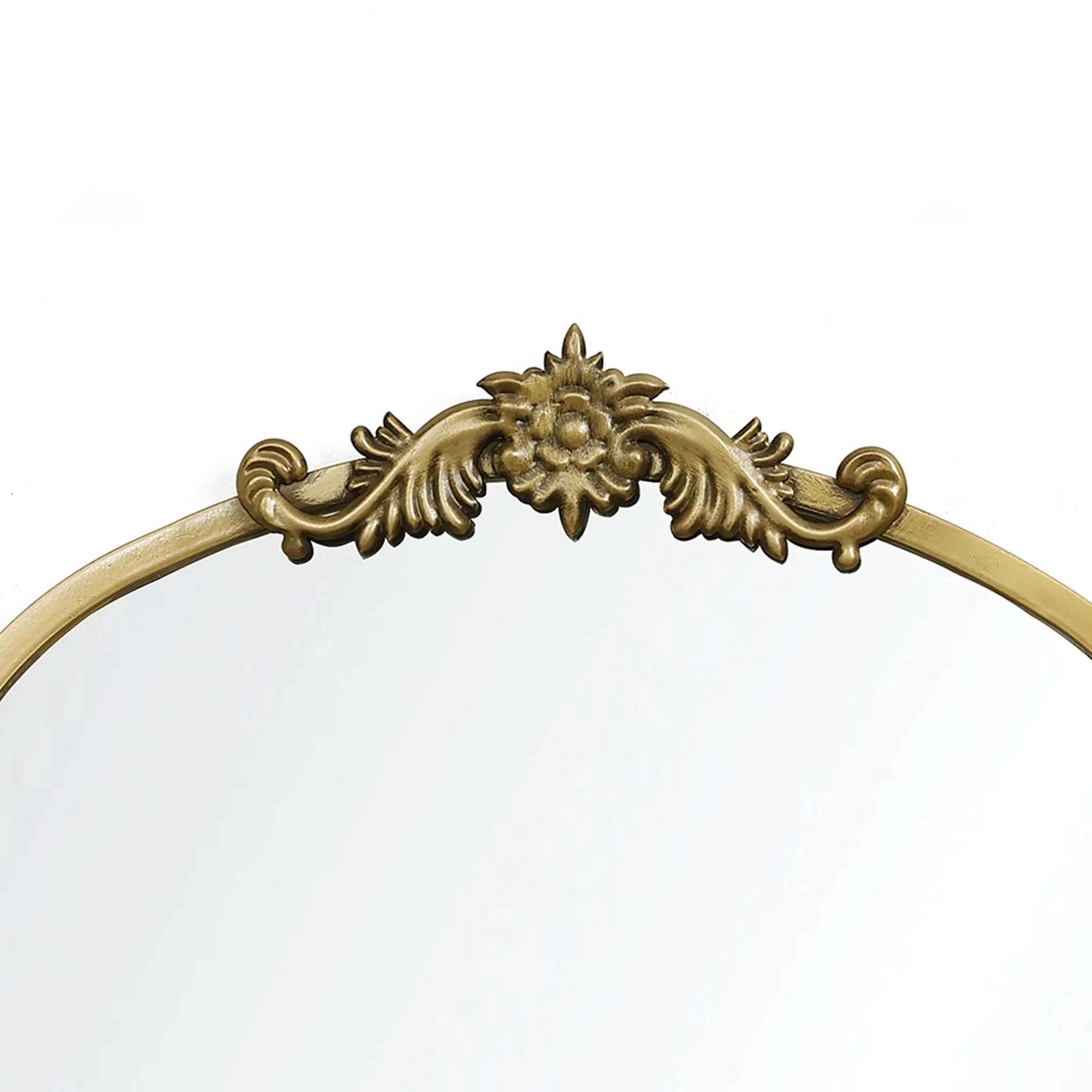 The LuxenHome Rêverie vintage gold accent mirror features an ornate metal frame with an antique finish, a floral design with swirling leaves, and an arched window silhouette. Its clear surface stands out beautifully against a plain white backdrop.