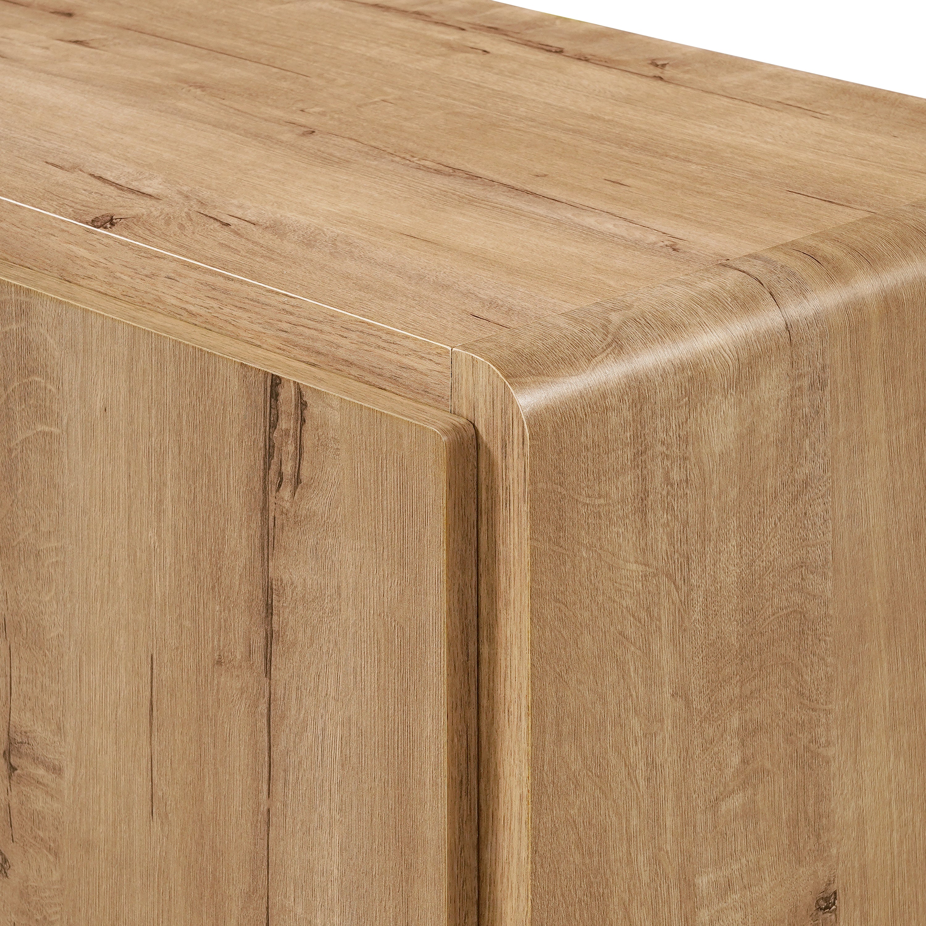 Close-up of a light wood cabinet with a rounded corner and visible grain texture.
