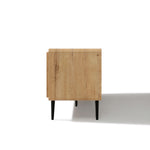 Side view of a minimalist TV stand with a light natural finish and four black legs with a shadow to the right.
