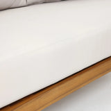 Close-up of a white cushion on an Outdoor Acacia Wood sofa frame, with a portion of a gray pillow visible at the top—perfectly paired with a Rope Sides Loveseat or Coffee Table Set for your patio.