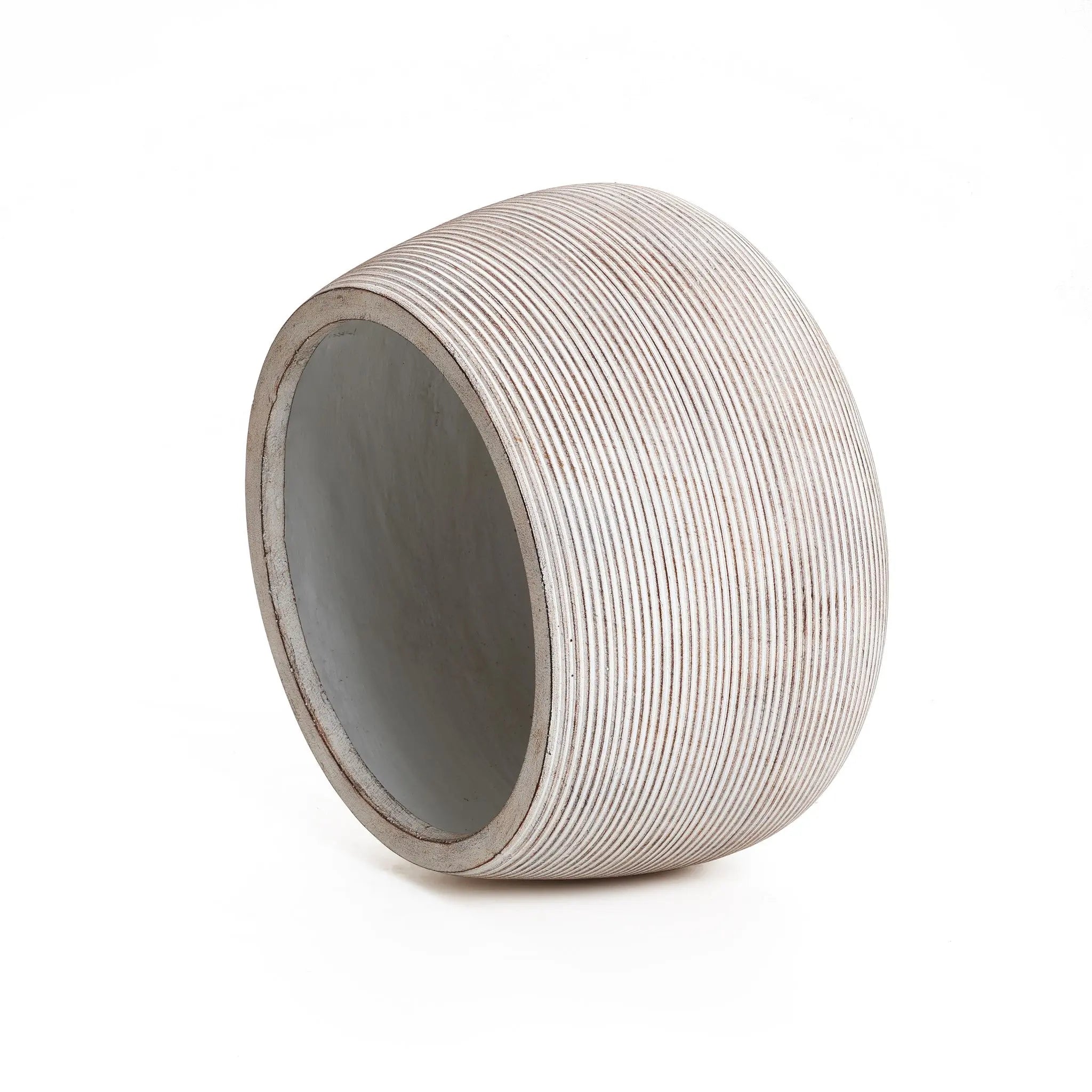 A cylindrical, ribbed, hollow object with a slanted top and open bottom, made from high-quality MgO in a speckled off-white finish. This minimalist design exudes elegance and simplicity.