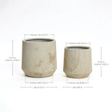 Two beige cylindrical pots with vertical ridges, perfect for any succulent garden. The larger marble planter stands at 14.17 inches tall and 14.57 inches in diameter, while the smaller one measures 11.42 inches in height and 11.81 inches across, ideal as indoor outdoor planters.