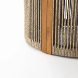 Close-up of a drum-shaped round end table featuring hand-woven rope and vertical slats, supported by a natural acacia wood beam on a white background.