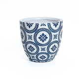 A modern ceramic pot with a blue circular pattern featuring floral designs, crafted from durable MgO material and placed against a plain white background. This stylish planter includes a convenient drainage hole to keep plants healthy.