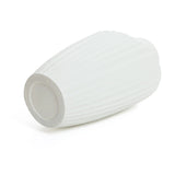 A modern abstract sculpture vase, white and ribbed, lies on its side with a narrow opening and flat base, showcasing its potential as a striking piece for contemporary home decor against a plain white backdrop.