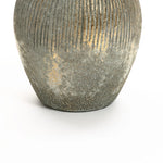 The LuxenHome Rustic gold and brown terracotta bud vase, 8.7 h, features an oval shape with a vertical ribbed design and an antique distressed look. Its gray and gold hues with a speckled metallic finish add charm to any home decor against a plain white background.