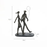 This modern resin bronze sculpture captures a couple walking arm in arm, with the man holding a balloon. Dimensions are 12.2 height, 8.4 width, and 3.7 depth, making it a charming home decoration piece.