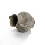 An aged earthenware jug lies on its side against a plain white background, resembling a LuxenHome Rustic mottled grey terracotta urn vase with handles, 12.1 h, featuring a rounded body, two small handles, and a narrow neck with a weathered appearance.