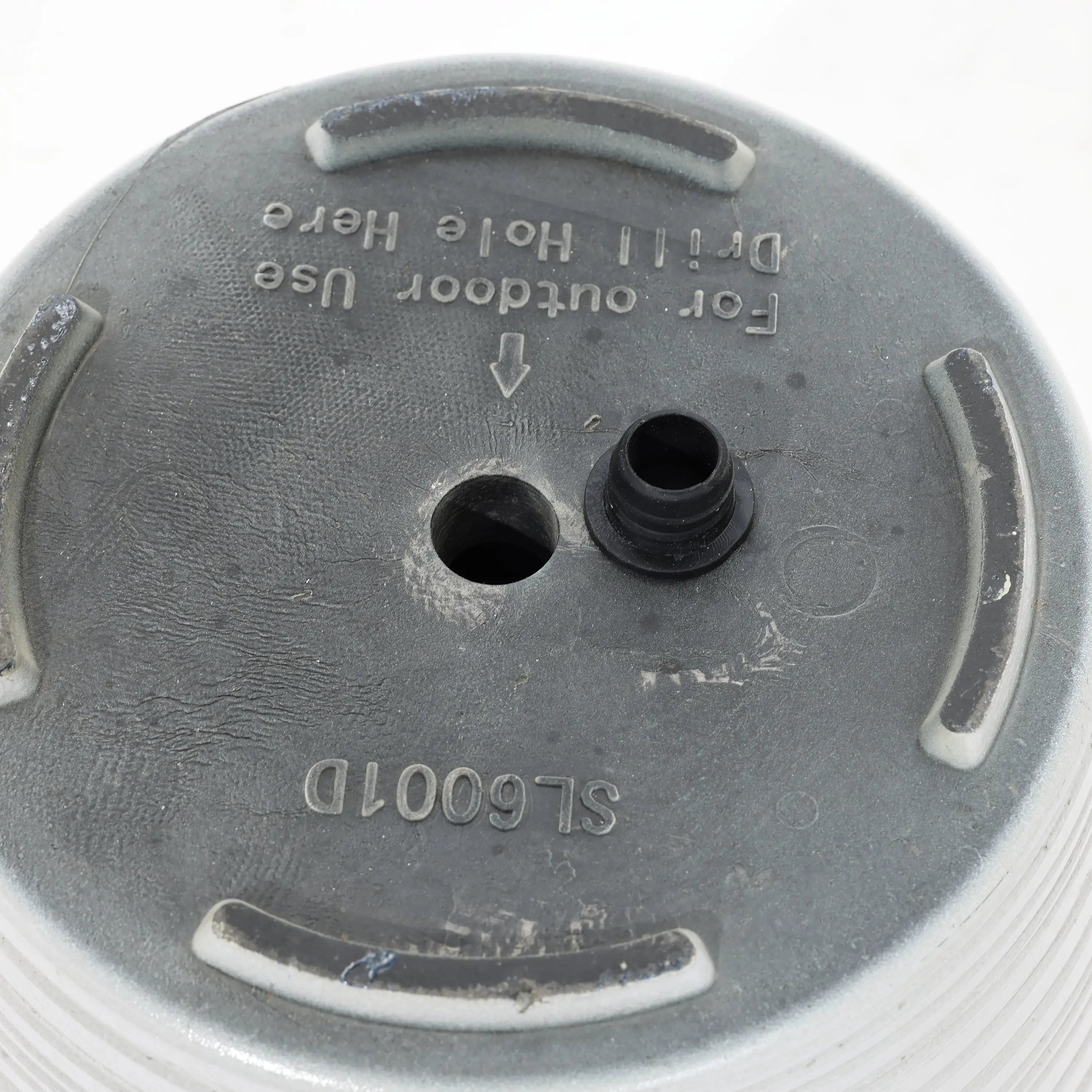 Close-up of a decorative circular outdoor planter featuring a central drainage hole and a removable black plug, marked For outdoor use and Drill hole here. This weather-resistant beauty is perfect for both indoor and outdoor use.