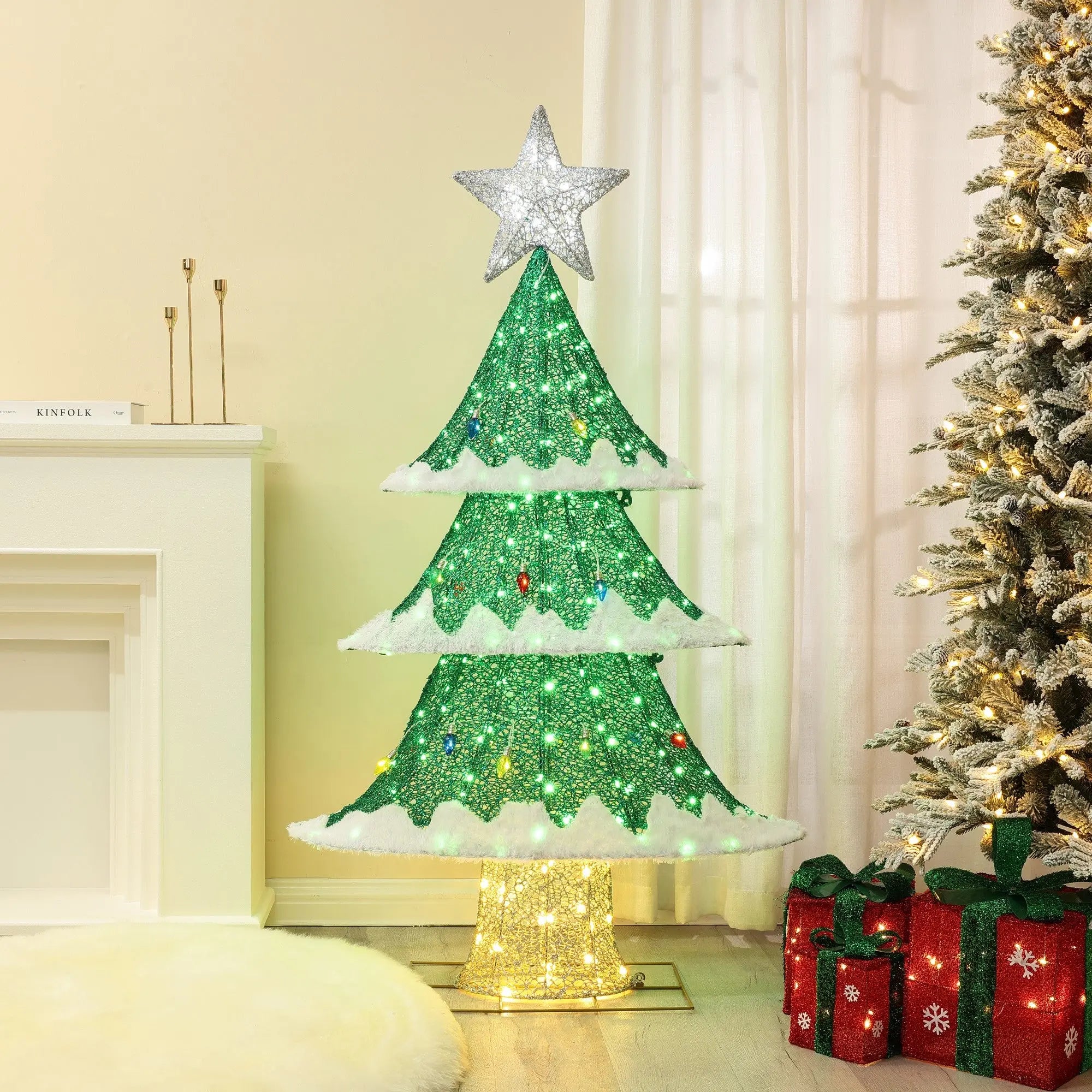 A glittering artificial Christmas tree adorned with LED lights in green and warm white, topped with a dazzling star. Perfect holiday decor, complete with charming gift boxes placed nearby on the floor.