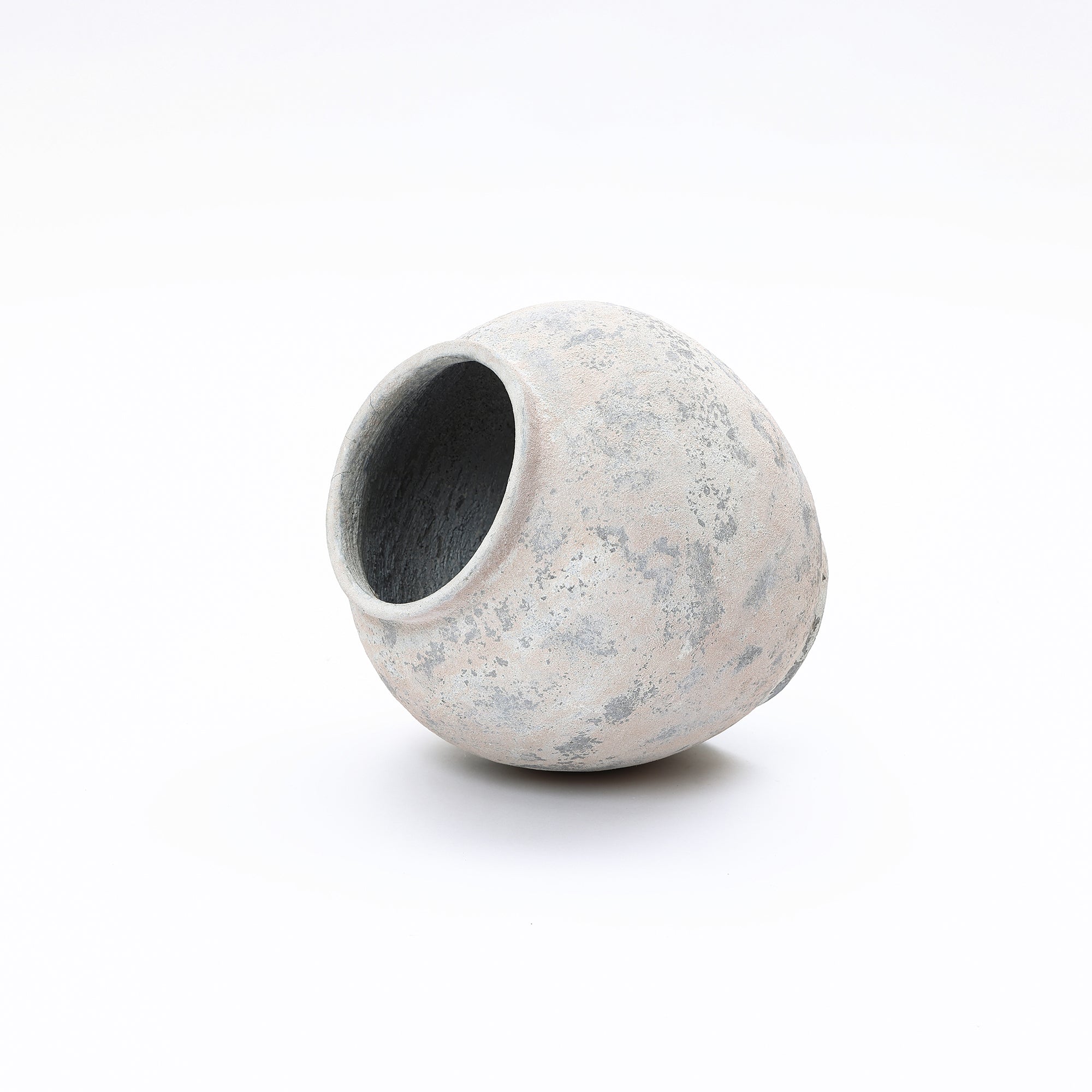 Asymmetrical modern minimalist vase with a wide opening and a textured, mottled gray and beige surface.