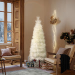 White artificial tree stands in living room corner, surrounded by wrapped gifts, warm lights.