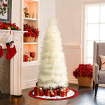 Slim pampas grass tree with wrapped gifts underneath stands in living room with red accents natural light.