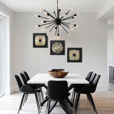 Modern dining room with a white square table, abstract metal wall art, and a black sputnik chandelier.