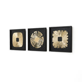 Three square black frames each display a gold abstract sunburst wall art design with different center shapes.