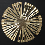 Circular metallic gold decorative object with radial cutouts and irregular edges.