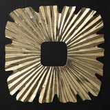 Square gold-toned sunburst wall art piece with radiating, textured lines and wavy edges, featuring a central square cutout.