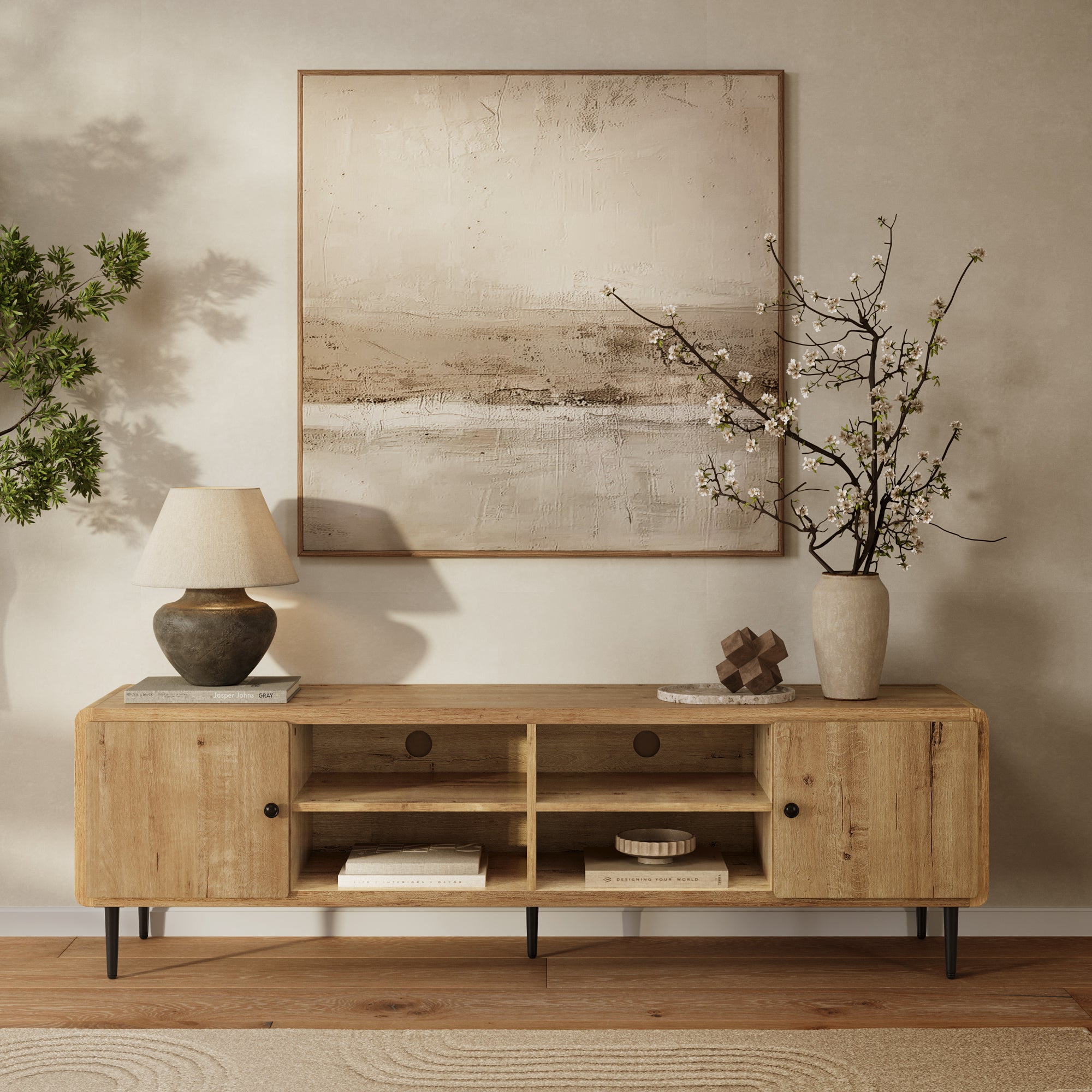 Wooden sideboard offers stylish storage for decor items, all set beneath a large painting on a neutral-toned wall.