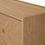 Close-up of a light wood dresser corner, showcasing a smooth, natural finish and subtle grain.