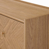 Close-up of a light wood dresser corner, showcasing a smooth, natural finish and subtle grain.