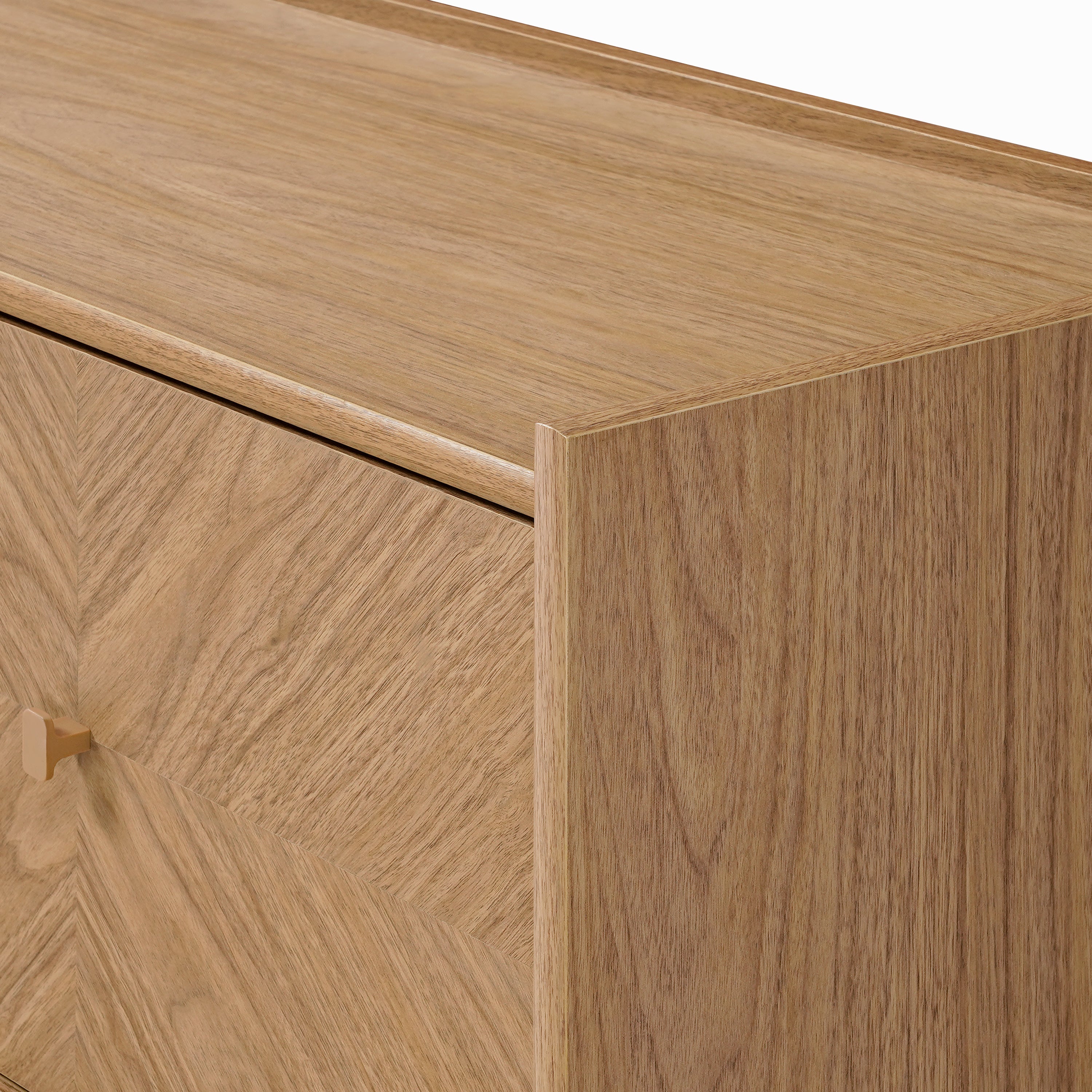Close-up of a light wood dresser corner, showcasing a smooth, natural finish and subtle grain.