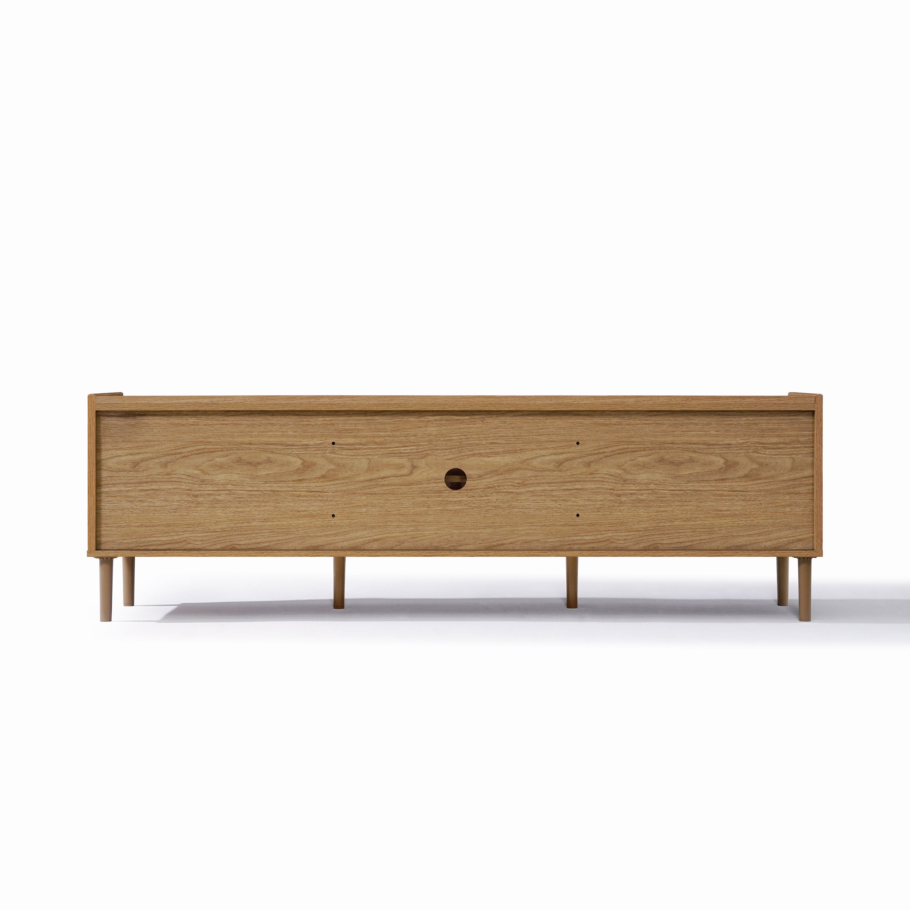 Rectangular wooden TV stand with slender legs, a central circular hole for cables, and a minimalist design.