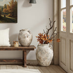 Terracotta Vase with rustic finish placed beside a wooden bench and door, one vase filled with autumn branches and orange leaves, creating a warm farmhouse décor scene.