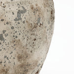 Close-up of a Terracotta Vase surface showing weathered speckled texture with gray and brown tones, highlighting its rustic farmhouse style against a white background.