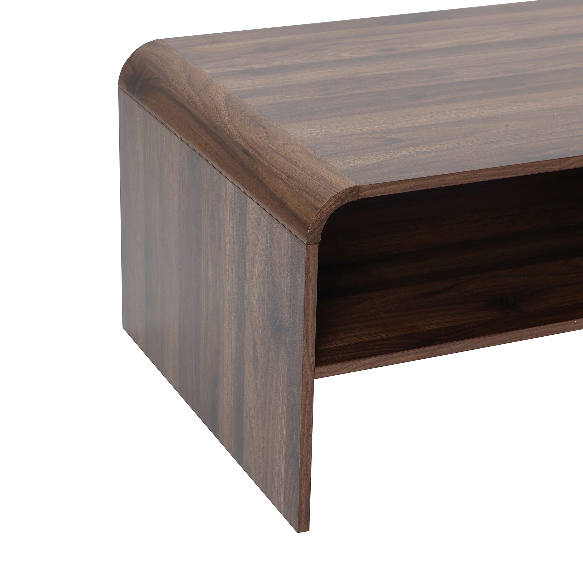 Close-up of the corner of a wooden coffee table with a smooth finish and an open shelf underneath.