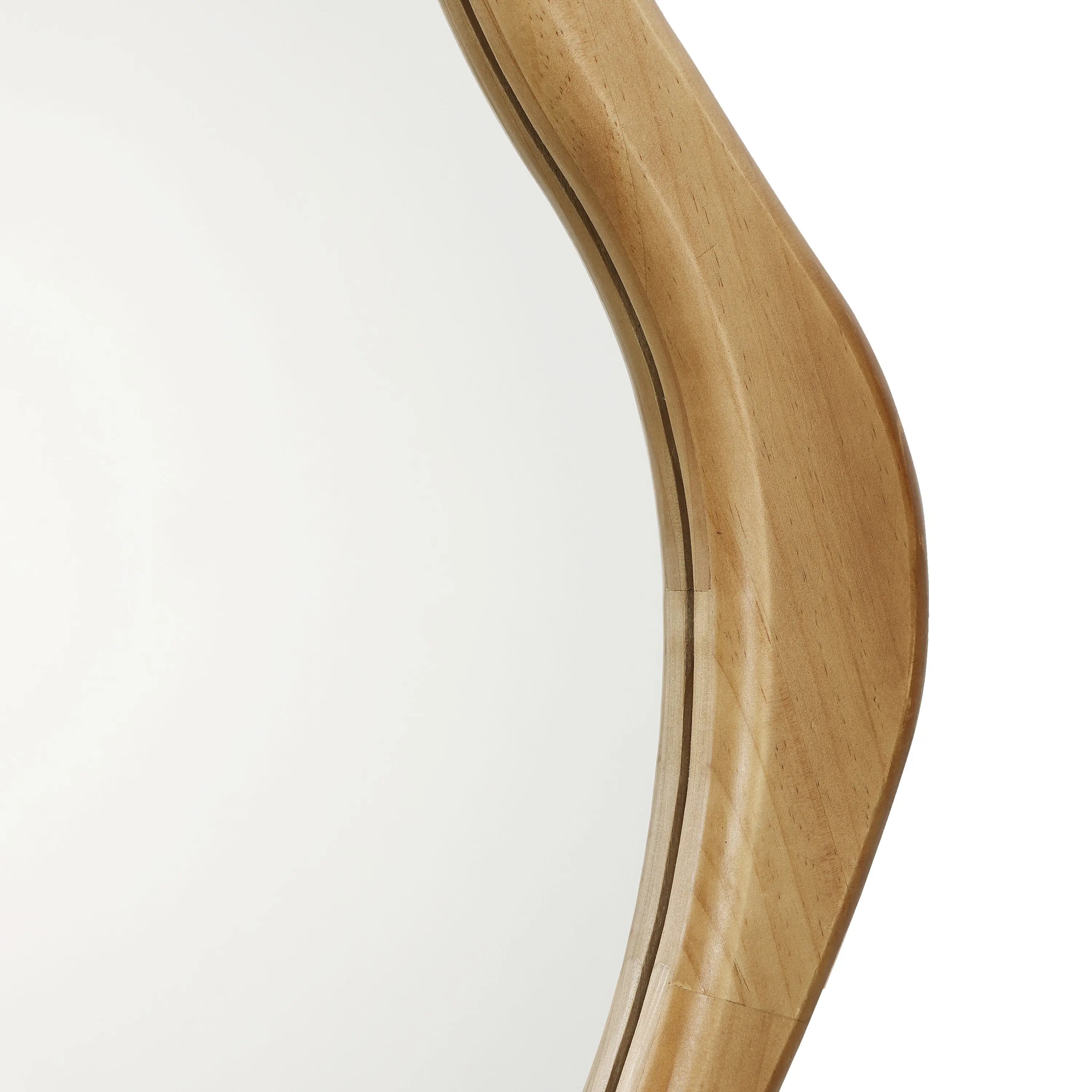Close-up of a round mirror with a smooth, curved design, encased in an elegant pine frame that exudes natural energy.