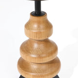 Close-up of a wooden lamp base crafted from birch wood with a smooth, rounded, tiered design. The natural finish reveals visible grain patterns, enhancing its charm as a unique piece of home decor.