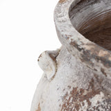 Close-up of a vintage-like, weathered surface of the LuxenHome Antique cauldron planter features a white textured finish with visible cracks, rough rim, and a decorative protrusion on its side, accentuating its rustic charm.