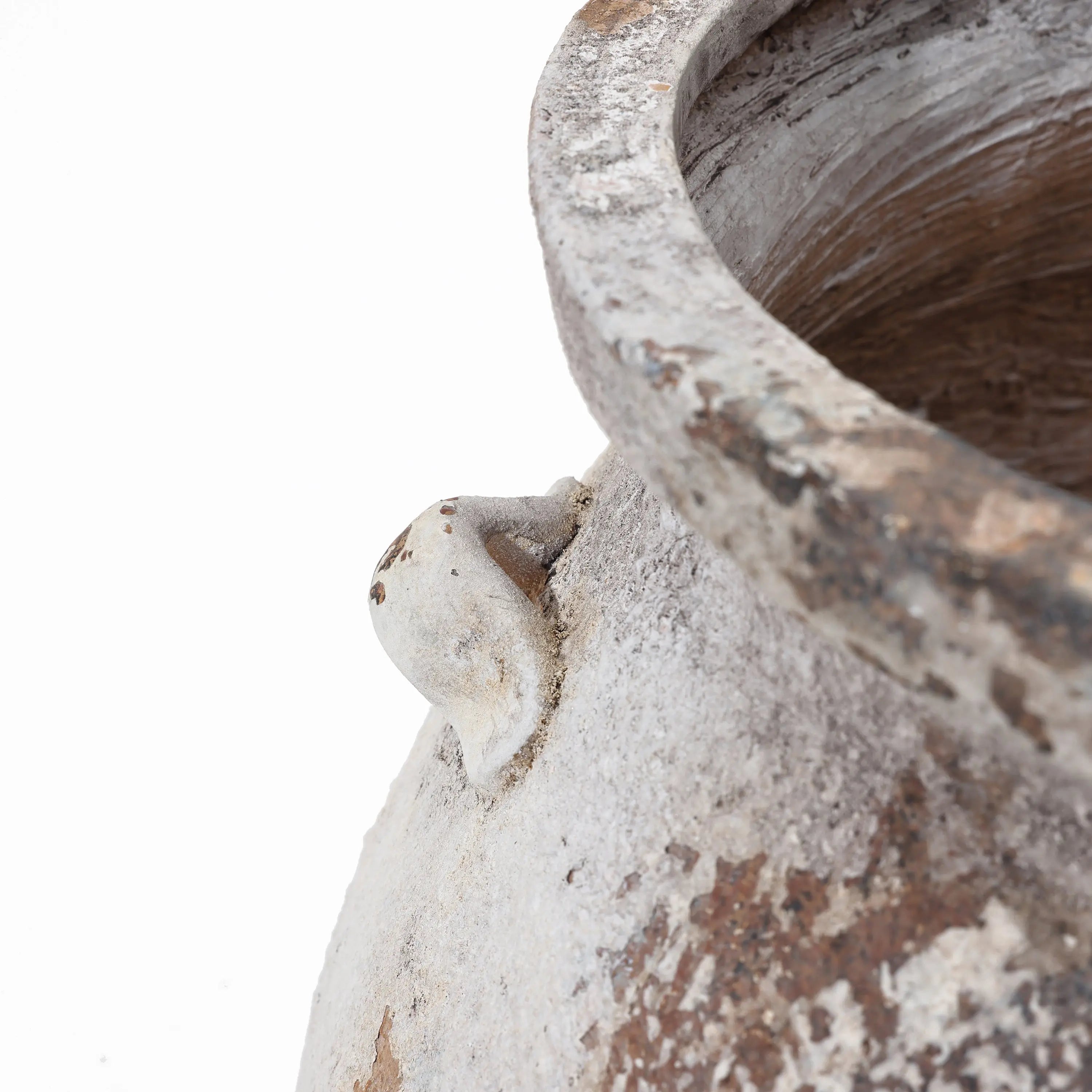 Close-up of a vintage-like, weathered surface of the LuxenHome Antique cauldron planter features a white textured finish with visible cracks, rough rim, and a decorative protrusion on its side, accentuating its rustic charm.