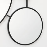 black-circular-mirror-and-black-rope-on-a-white-background