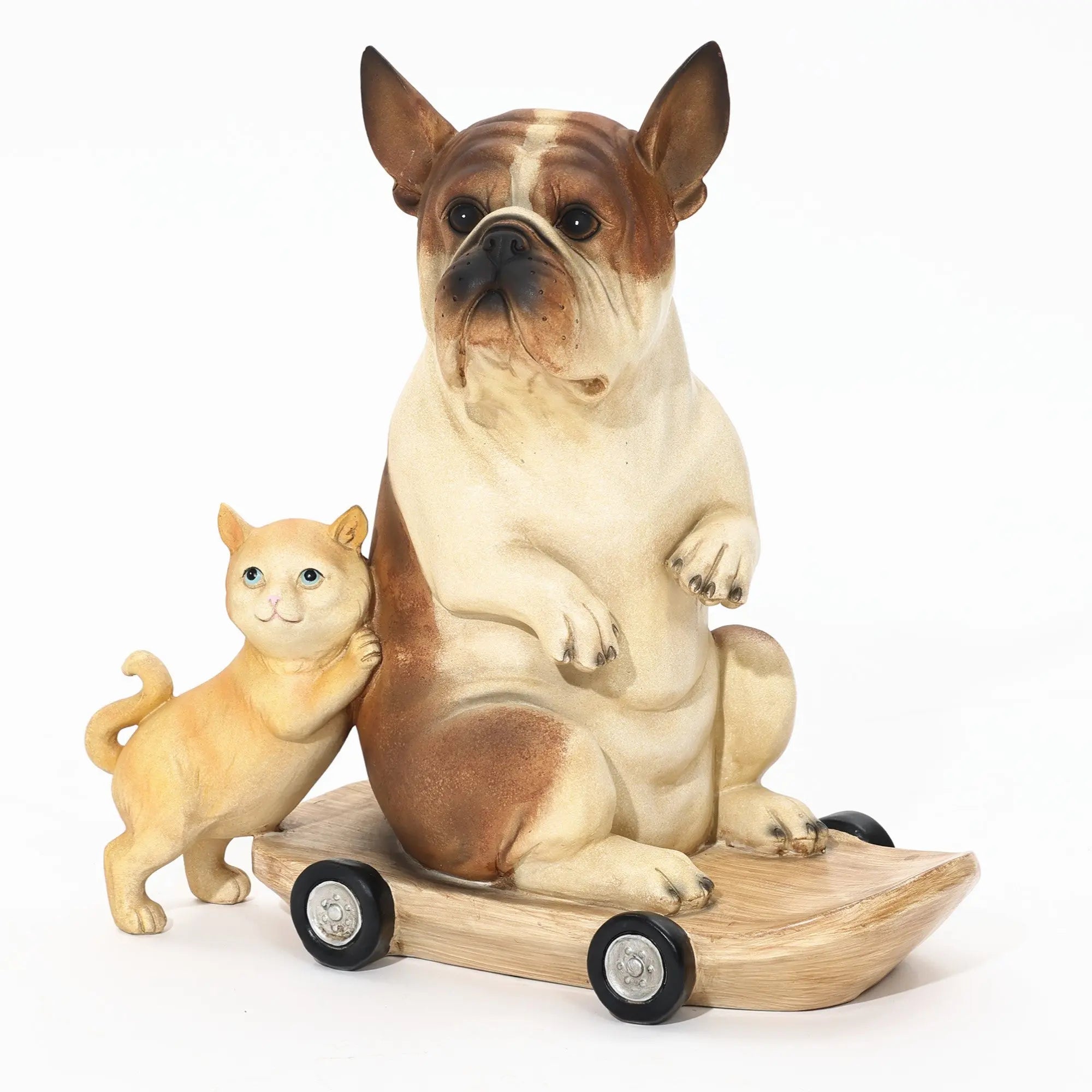 An eclectic style decor piece features a French bulldog statue crafted from clay, perched on a wooden skateboard with wheels. Beside it, a smaller clay cat leans casually, adding charm to this playful scene.