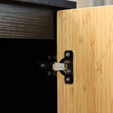 Close-up of a black and wood-tone cabinet door slightly ajar, revealing a metal hinge attached to the frame. The contemporary design is accentuated by subtle natural bamboo strips that add texture to the composition.