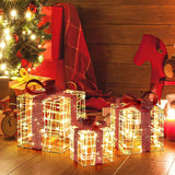 Three wire-frame lighted gift boxes glow near a decorated Christmas tree, surrounded by wrapped presents, a toy horse, and festive decor on a wooden floor.