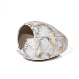 Ceramic vase with a textured, speckled surface reminiscent of marble in shades of white, grey, and brown. The design features an asymmetrical, elongated shape with a cutout opening, evoking a broken egg design.