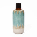 Ceramic vase with a glossy finish, featuring a zigzag pattern in blue, cream, and brown. This coastal-inspired vase adds nautical charm to any tabletop decor.
