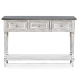 A farmhouse-inspired table featuring a dark top, three front drawers with decorative knobs, carved details, and a lower shelf, all finished in distressed white—perfect as a stylish storage console table for any home.