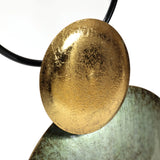 The LuxenHome Glam Dishes Metal Wall Art, set of 2, showcases a modern metallic sculpture with a textured golden disc overlapping a curved greenish-gold surface and a black rounded edge. Ideal for contemporary spaces, the contrasting colors and textures make it stunning against white walls.