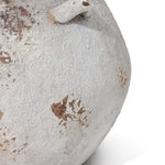 Close-up of a LuxenHome Antique cauldron planter with weathered and rusted metal. The image highlights a curved area with vintage rustic charm, showing patches of rust and peeling paint on a greyish-white background.