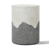 A cylindrical stool with a smooth white upper section and a textured gray lower section, resembling a cement side table.
