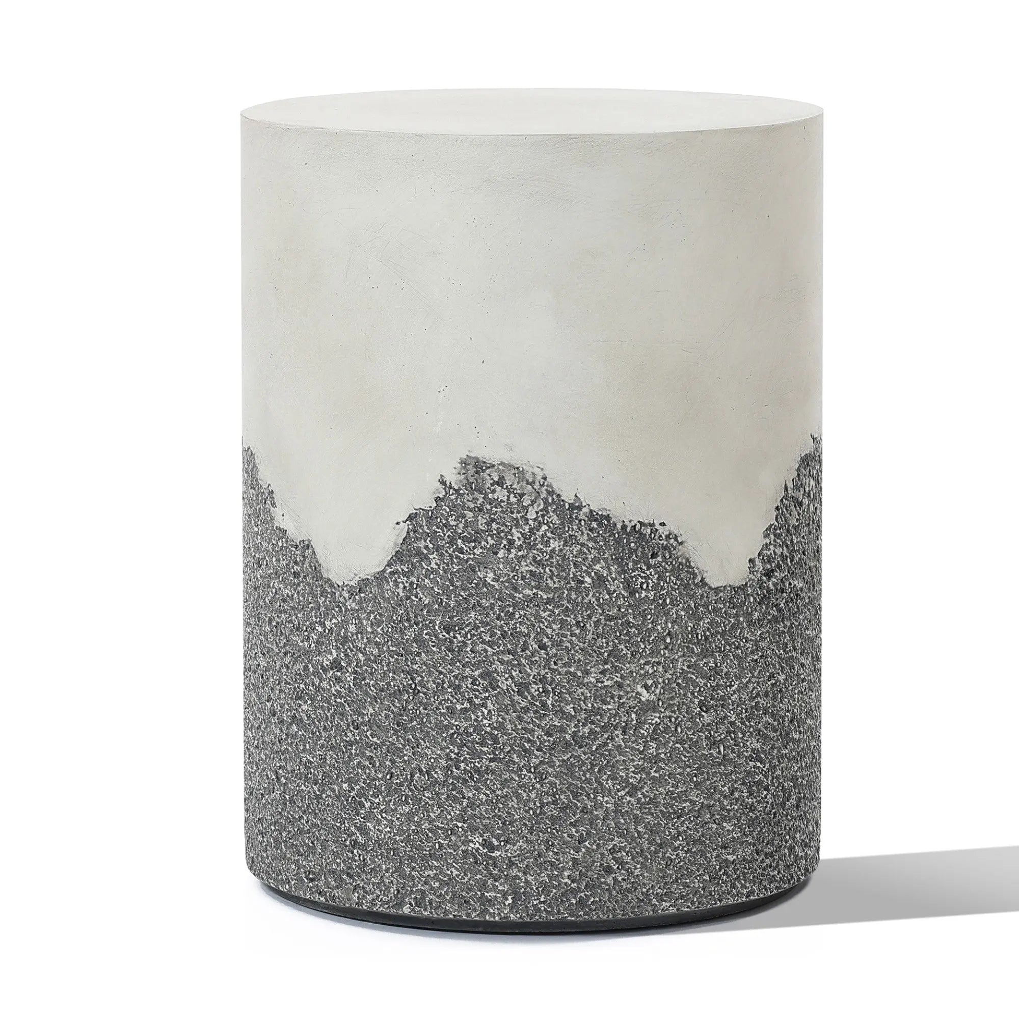 A cylindrical stool with a smooth white upper section and a textured gray lower section, resembling a cement side table.