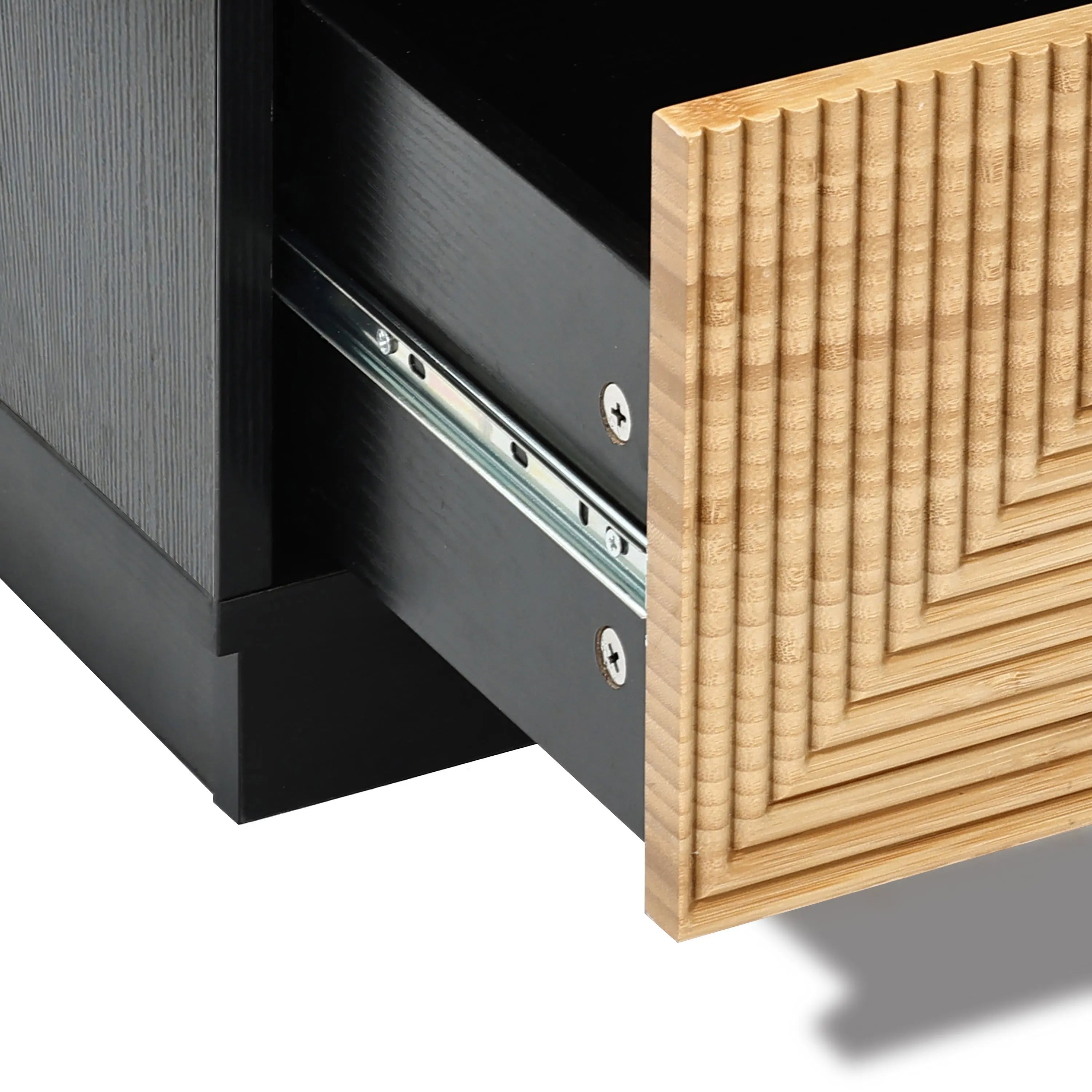 Close-up of the Ethan bamboo stripped black nightstand by LuxenHome with a partially open drawer showcasing a wooden front panel with a geometric pattern. The visible metal sliding mechanism highlights its modern and minimalist style.