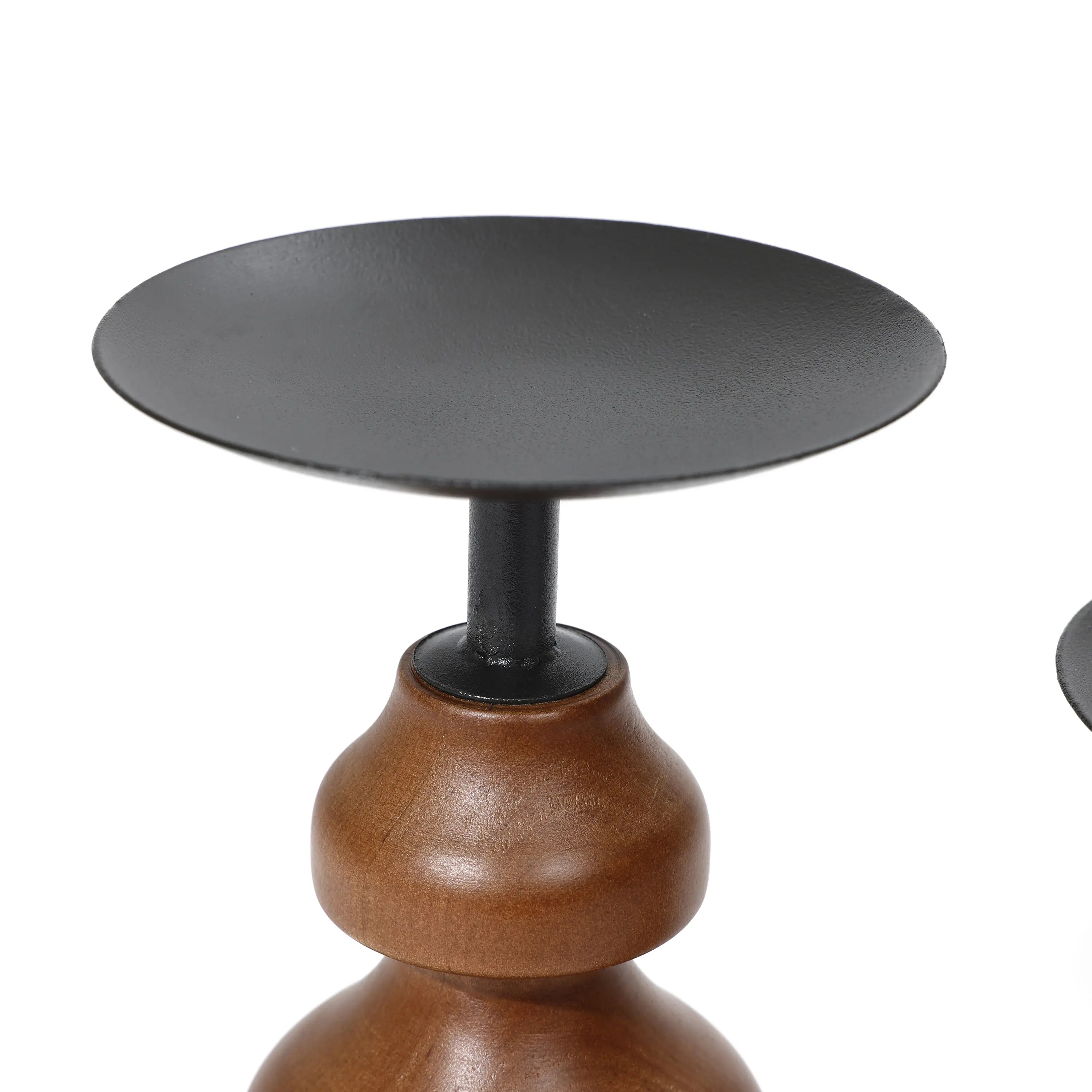Close-up of a decorative candle holder, featuring a birch wood base and a flat, circular metal top, perfect for enhancing your home decor.